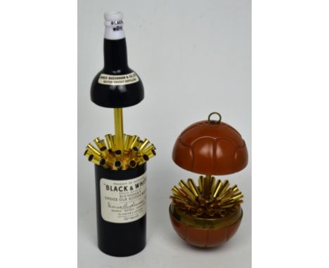 A 'Black and White Buchanan's Choice Old Scotch Whisky' bottle-shaped musical cigarette dispenser, metal football-shaped ciga