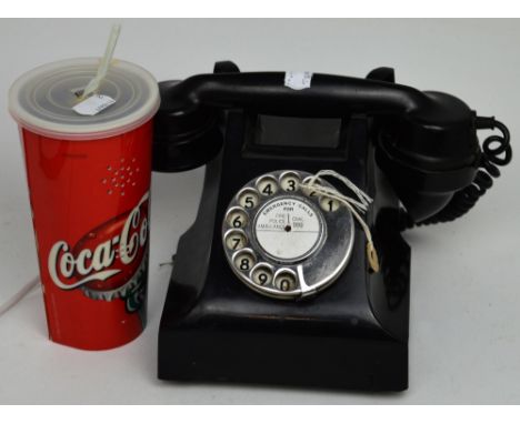 A vintage black telephone with English numbered dial and a contemporary phone in the form of a Coca-Cola can (2).