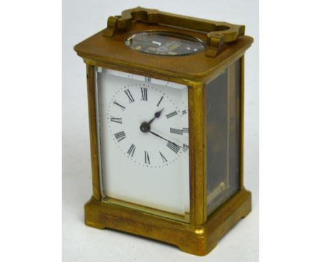A late 19th-early 20th century French R & Co Paris brass carriage clock, rectangular white enamel dial set with Roman numeral
