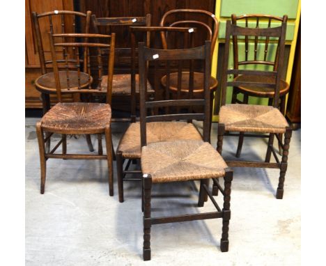 Two matching ladder-back rush-seated chairs, a stick-back rush-seated chair, two other vintage chairs, a bedroom chair and an