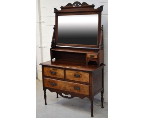 An Edwardian mahogany and burr walnut dressing table, large swivel mirror over shelf and small drawer on chest of two short d