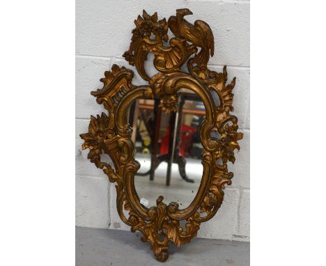 A 19th century gilt wall mirror with scrolling foliate and floral decoration and ho-ho bird finial, height 77cm.