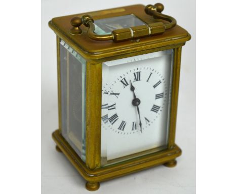 A late 19th century small French brass carriage clock stamped 'France' to back, rectangular white enamel dial set with Roman 