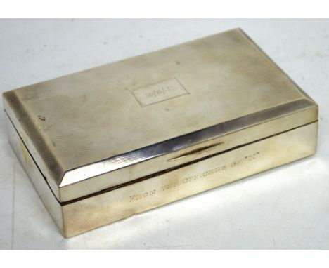 A George VI hallmarked silver engine-turned cigarette box with wooden liner, inscribed 'From the Offices of X', cartouche to 