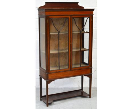 An Edwardian mahogany and boxwood strung display cabinet, two glazed panel doors on tapering legs to lower shelf, width 90cm,