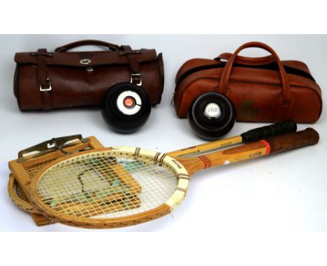 A cased pair of wooden bowls with smaller similar example, a further set of Drakes Pride cased bowls, a Dunlop Maxply tennis 