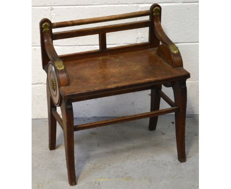 A Shoolbred & Co oak stool/piano stool, low back and brass-mounted decoration, width 54.5cm.   CONDITION REPORT  Waer and bru