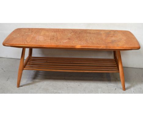 A light Ercol rectangular coffee table above slatted magazine rack, length 105cm.