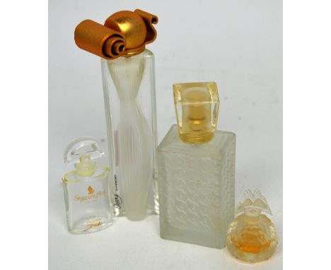 Four designer perfume bottles to include a miniature Lalique perfume bottle with butterfly stopper, Christian Dior 'Miss Dior