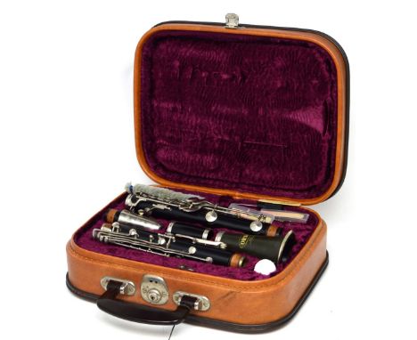 A cased Corton clarinet with reeds and cleaning equipment.
