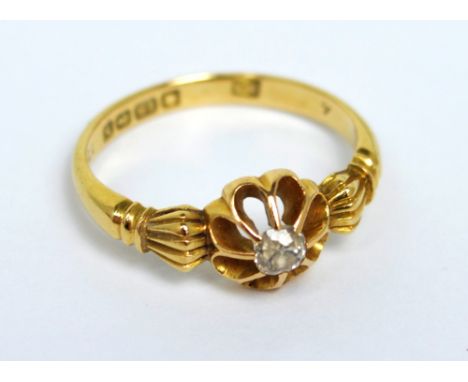 An 18ct yellow gold solitaire diamond ring set in raised floral mount with fancy shoulders, size O 1/2, approx 3.7g.