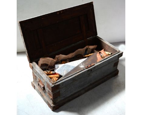A late 19th-early 20th century toolbox containing a quantity of vintage tools to include saws, screwdrivers, chisels etc.