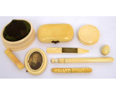 A collection of late 19th-early 20th century ivory to include an oval pin cushion, three needle cases; one with circular desi