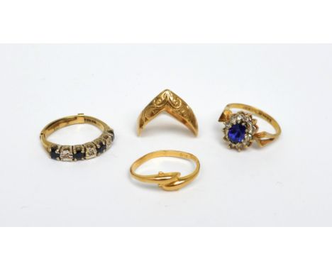 Four 9ct yellow gold rings to include a dolphin-decorated ring, a wishbone-shaped ring, a diamond and sapphire half-eternity 