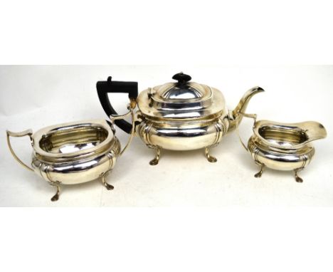 A George V hallmarked silver tea service comprising teapot, milk jug and twin-handled sugar bowl, all raised on pad feet, Jam