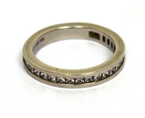 A platinum and square-cut diamond set half-eternity ring, size K, approx 4.9g.   CONDITION REPORT  Channel set, cannot see al