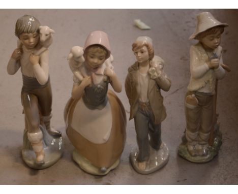 Three Nao figure groups; a boy with lamb over his shoulder, a girl with lamb over her shoulder, a boy holding a staff with sm