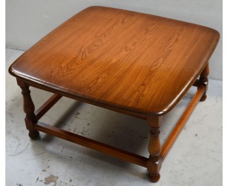 A modern Ercol elm square coffee table on turned legs with stretchers, width 75cm. 