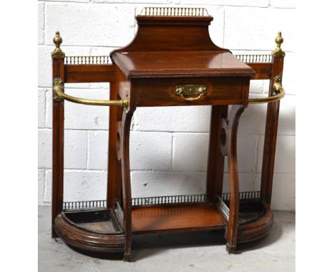 A Shoolbred & Co oak hall stand with cast brass gallery, brass finial decoration, single central drawer flanked by stick stan