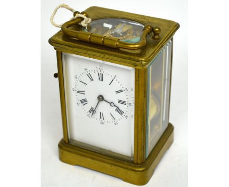 An early 20th century brass repeater carriage clock with gong strike, rectangular white enamel dial set with Roman numerals a