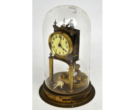 A late 19th-early 20th century brass domed clock with weighted pendulum, cream enamel dial set with Arabic numerals, height 3