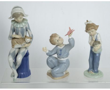 Three Nao figures; Pierrot, young boy with an airplane and a girl with a dog (3).