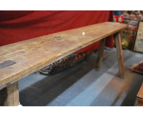 An antique oak stick leg pig stool/bench, 163 cm long x 46 cm high