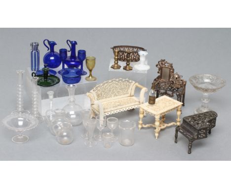 A small collection of dolls house furniture and interior pieces, 19th century and later, including a pierced bone seat and ta