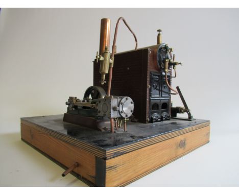 A stationary steam engine with Bassett-Lowke gas fired boiler, pressure gauge missing, with water feed pump take off to singl