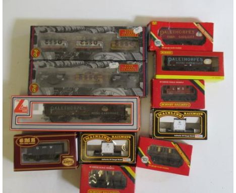 Eleven goods wagons by Bachmann and Hornby including petrol tankers, coal trucks and P.O. wagons, all items boxed, F-G (Est. 