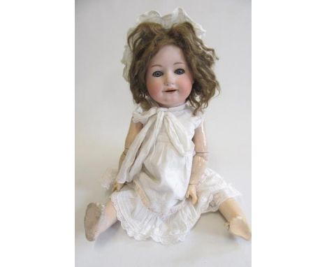 A W. Goebel bisque socket head doll, with blue glass sleeping eyes, open smiling mouth with four top teeth, brown wig, jointe