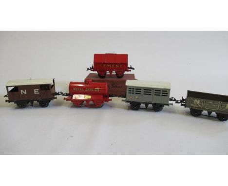 Five Hornby goods wagons comprising Royal Daylight tank, red cement, N.E. cattle van, N.E. coal truck and N.E. brake van, G-E