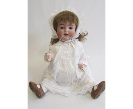 A Kammer &amp; Reinhardt bisque socket head character doll with blue glass flirty eyes, sleeping eyelids, open mouth, two top