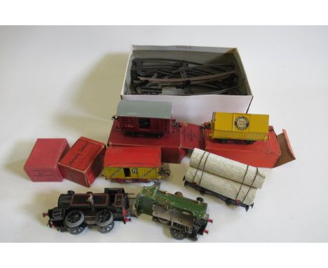 Hornby cement wagon, milk traffic van, Bananas van, two platform clockwork tin locomotives and track, and a Mamod wood wagon,