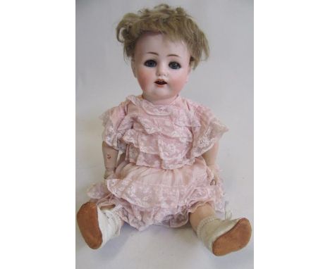 A Max Handwerck Bebe Elite bisque socket head doll, with blue glass sleeping eyes, open mouth with two top teeth and tremblin