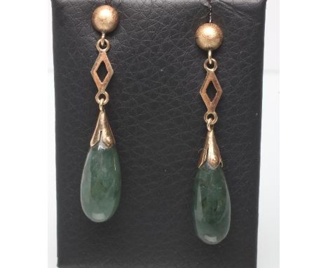 A PAIR OF NEPHRITE EAR BOBS, the polished oval stones set to an open lozenge panel and stud (Est. plus 21% premium inc. VAT)U