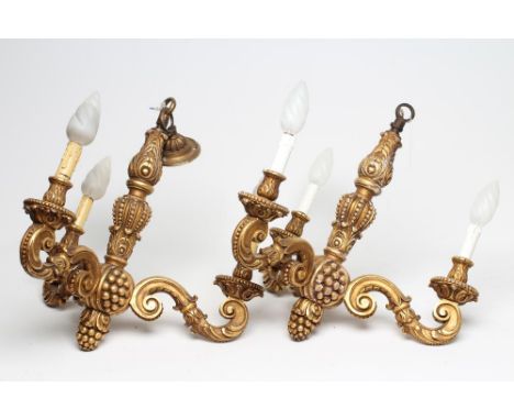 A PAIR OF CARVED GILT WOOD LIGHT PENDANTS, 20th century, the leaf and berried baluster stem with pineapple finial issuing thr