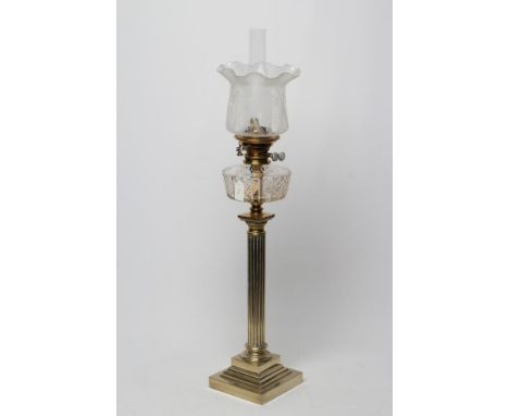 A SILVER PLATED TABLE LAMP, c.1900, the fluted column supporting a diamond and slice cut clear glass reservoir, the etched gl