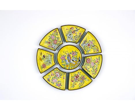 A CANTON ENAMEL SUPPER SET, comprising central circular dish and seven outer fan shaped segments, all painted in colours with
