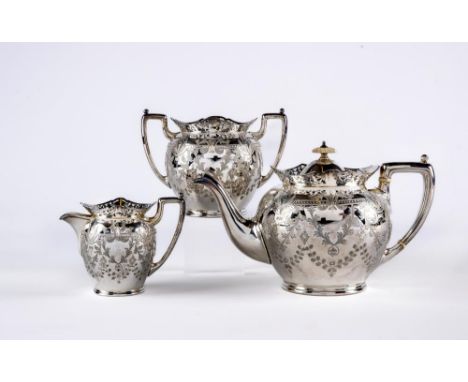 A LATE VICTORIAN SILVER THREE PIECE TEA SERVICE, maker Cooper Bros., Sheffield 1900, of globular form with everted scroll pie