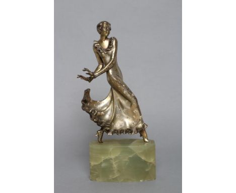 AFTER LORENZL - an Art Deco spelter figure modelled as a young fashionable lady wearing a daisy painted long frilled dress, s