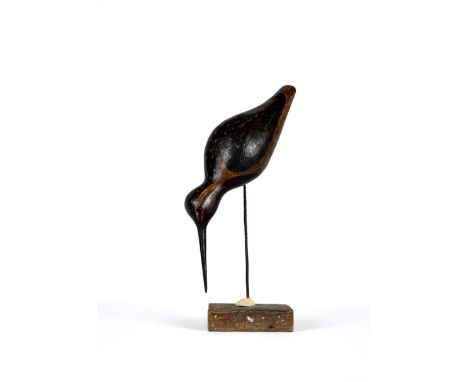 GUY TAPLIN (b.1939) "Godwit", a carved and painted model, 12 1/2" long, on a rustic metal support with shell terminal on oblo