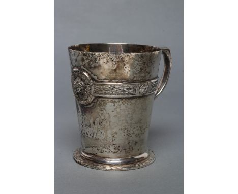 AN IRISH SILVER CHRISTENING MUG, maker Wakeley & Wheeler, Dublin 1920, of flared cylindrical form, cast and applied with a Ce