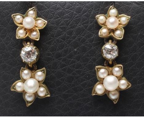 A PAIR OF LATE VICTORIAN STUD EARRINGS, the six pearl cluster hung with an old cut diamond, pendant with a further pearl clus