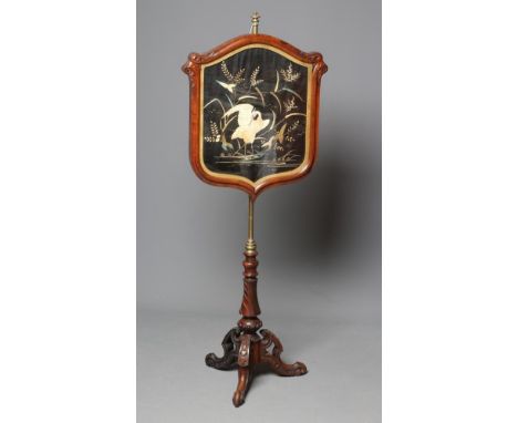 A VICTORIAN ROSEWOOD POLE SCREEN, the leaf carved shield with needlework panel depicting a crane amongst bulrushes, on turned