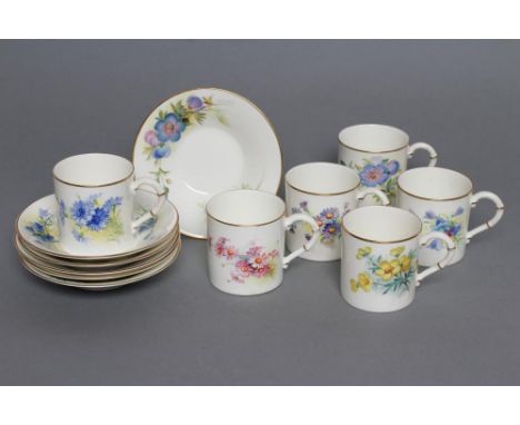 A SET OF FOUR ROYAL WORCESTER CHINA COFFEE CANS AND SAUCERS, 1936, all painted in polychrome enamels by Powell with sprays of