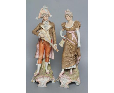 A PAIR OF ROYAL DUX PORCELAIN FIGURES, early 20th century, modelled as a young gentleman in 18th century style garb playing a