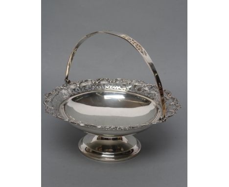 A SILVER BASKET, maker's mark rubbed, Birmingham 1945, of circular form, the everted rim stamped and pierced with scrolls wit