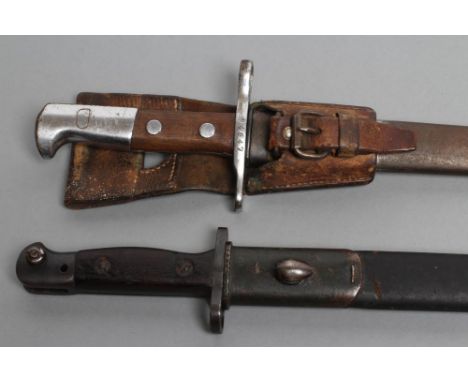 TWO EARLY 20TH CENTURY BAYONETS, comprising a Swiss M1918 by Waffenfabrik Neuhausen, with metal scabbard and leather frog, an