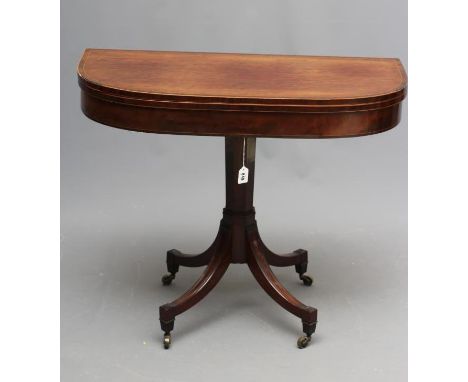 A REGENCY "PLUM PUDDING" MAHOGANY FOLDING CARD TABLE of rounded oblong form, the rosewood banded and string inlaid top openin